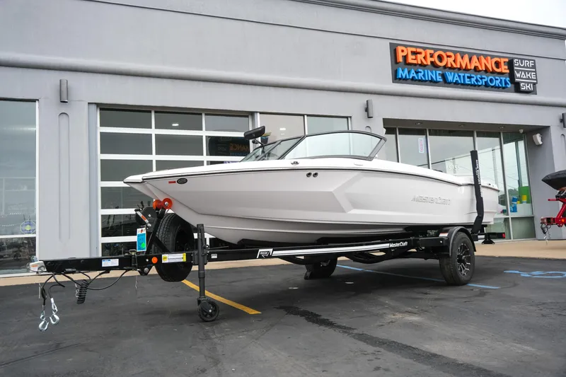 Slide: The Image of 2026 MasterCraft ProStar 190 boat on trailer outside Performance Marine Watersports store. - 12