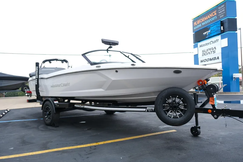 Slide: The Image of 2026 MasterCraft ProStar 190 boat on trailer at marine dealership. - 15