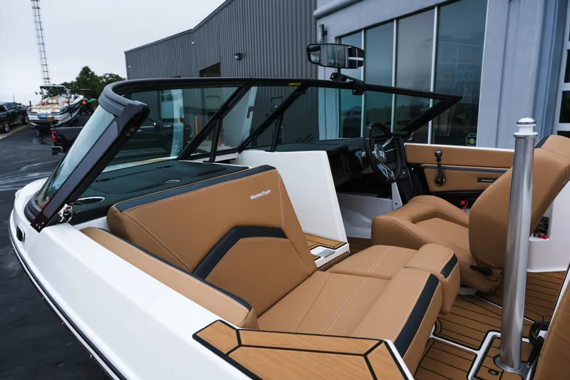 Slide: The Image of 2026 MasterCraft ProStar 190 boat interior with tan leather seats and modern dashboard. - 8