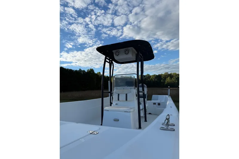 Slide: The Image of 2009 Carolina Skiff 218 DLV boat under a partly cloudy sky. - 3