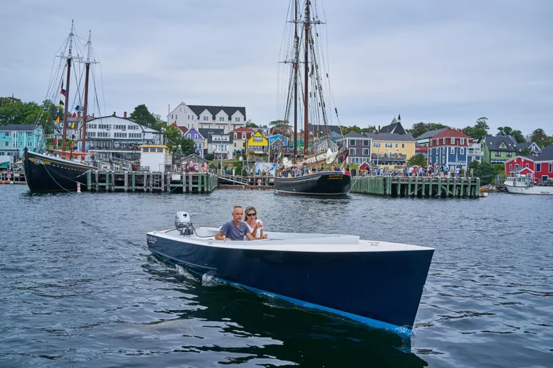 Slide: The Image of A modern 2023 Custom Uffa Fox boat on scenic waterfront with colorful buildings. - 1