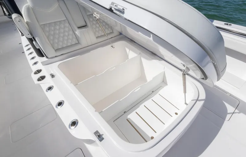 Slide: The Image of 2025 Invincible 35 Catamaran storage compartment with open lid, showcasing spacious interior design. - 10