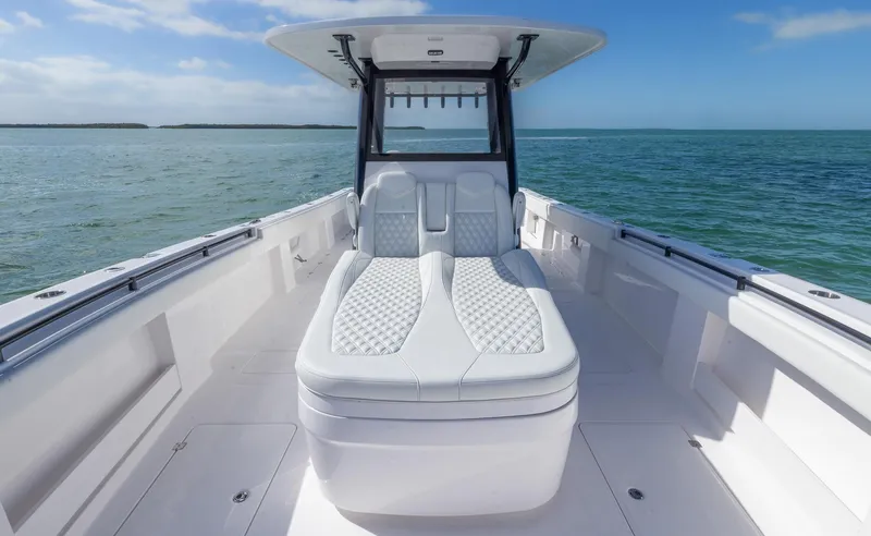 Slide: The Image of 2025 Invincible 35 Catamaran with luxurious seating on open water. - 13