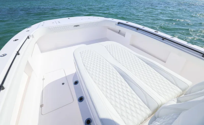 Slide: The Image of 2025 Invincible 35 Catamaran with luxurious seating on calm waters. - 16