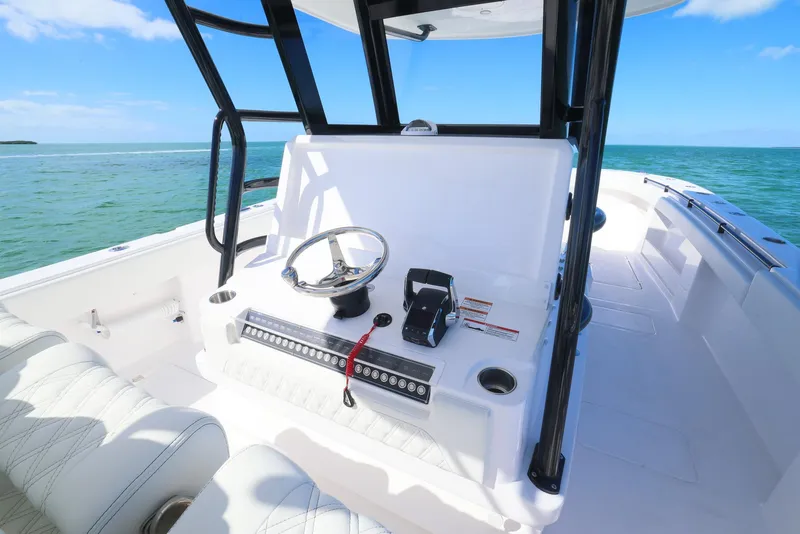 Slide: The Image of 2025 Invincible 35 Catamaran helm with ocean view, featuring modern controls and seating. - 17