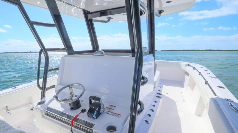 Slide: The Image of 2025 Invincible 35 Catamaran on open water, showcasing sleek design and modern controls. - 19