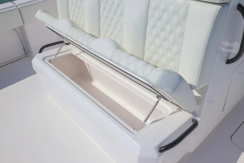 Slide: The Image of 2025 Invincible 35 Catamaran seat with storage compartment, featuring quilted upholstery. - 26