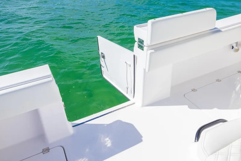 Slide: The Image of Invincible 35 Catamaran 2025 with open side door, overlooking clear green water. - 30