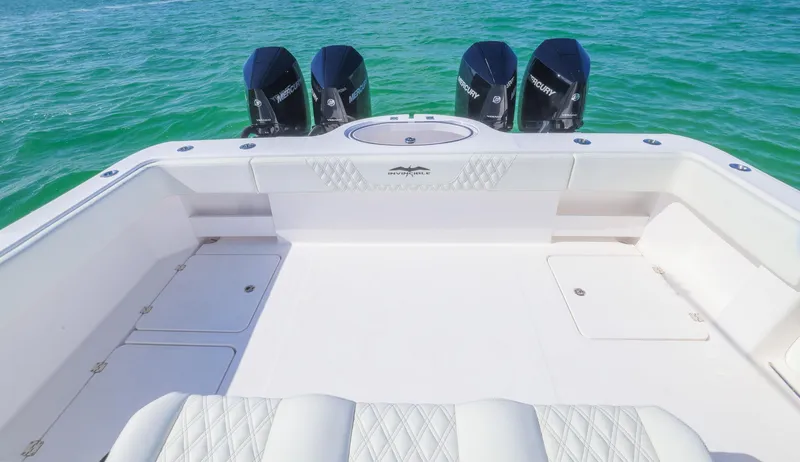 Slide: The Image of 2025 Invincible 35 Catamaran with quad engines on turquoise water. - 31