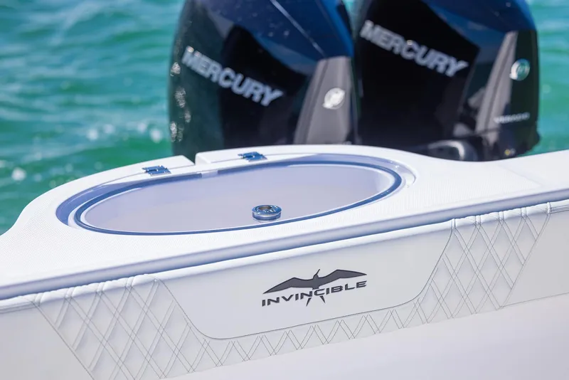 Slide: The Image of 2025 Invincible 35 Catamaran with Mercury engines on turquoise water. - 32