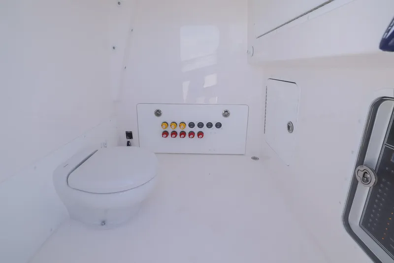Slide: The Image of 2025 Invincible 35 Catamaran interior with modern marine toilet and control panel. - 35