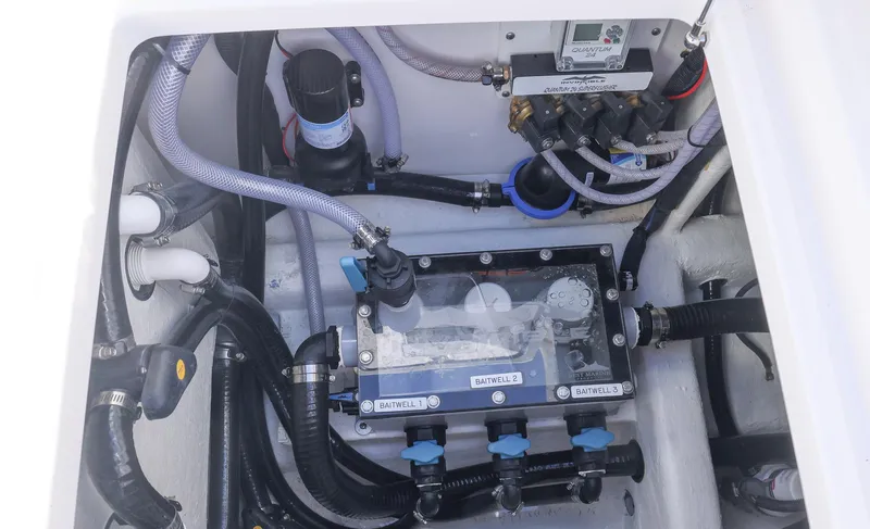 Slide: The Image of Engine compartment of 2025 Invincible 35 Catamaran with visible hoses and components. - 39