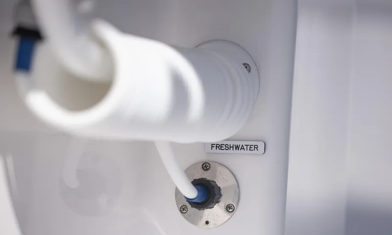 Slide: The Image of Freshwater connection on 2025 Invincible 35 Catamaran, featuring white hose and labeled port. - 42