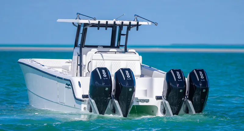 Slide: The Image of 2025 Invincible 35 Catamaran with quad engines cruising on turquoise waters. - 45