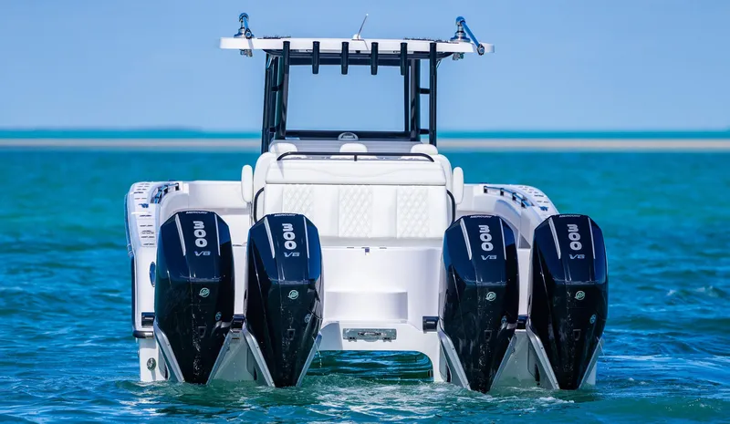 Slide: The Image of 2025 Invincible 35 Catamaran with quad outboard engines on clear blue water. - 7
