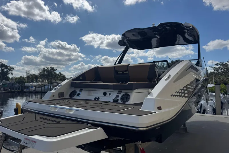 Slide: The Image of 2022 Scarab 285 ID boat docked under a partly cloudy sky. - 10