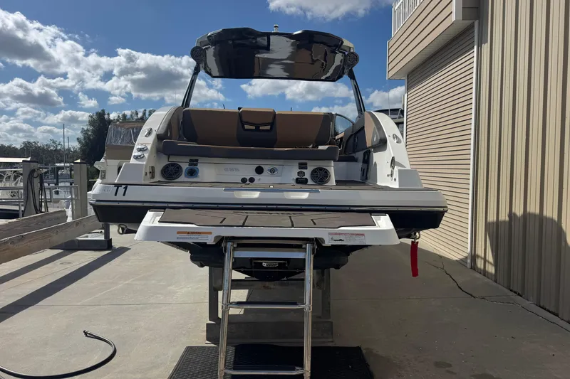 Slide: The Image of 2022 Scarab 285 ID boat on dock, rear view with ladder and speakers. - 12