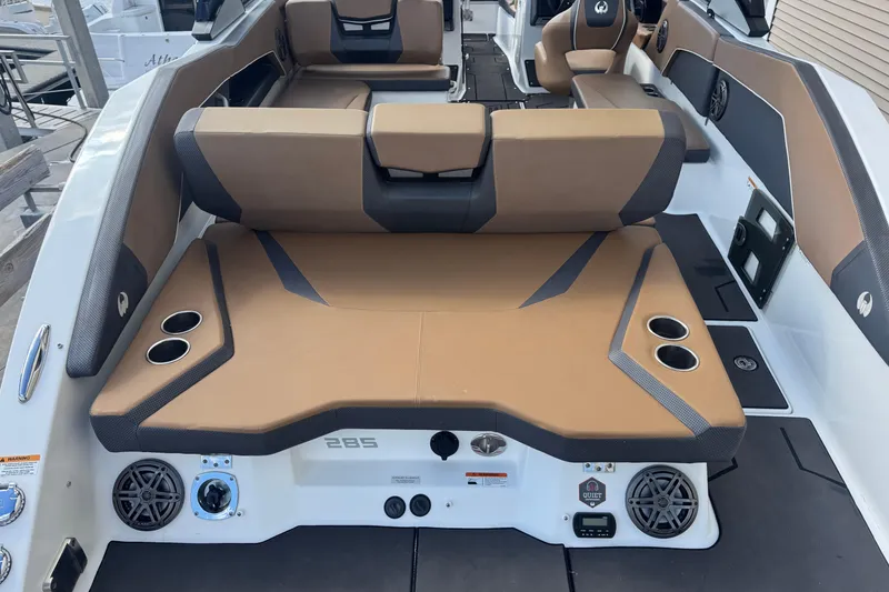 Slide: The Image of 2022 Scarab 285 ID boat interior with tan seating and cup holders. - 18