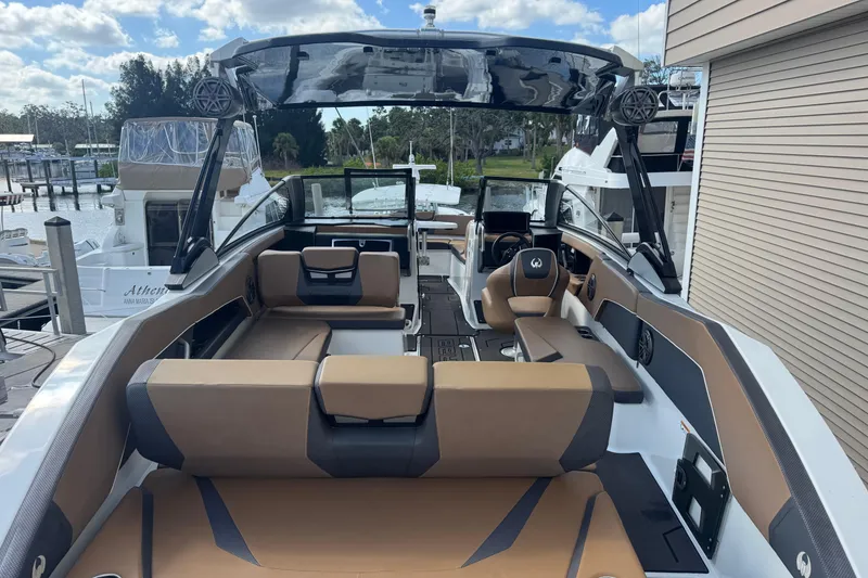 Slide: The Image of 2022 Scarab 285 ID boat with spacious seating and modern design at a marina. - 20