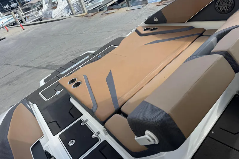 Slide: The Image of 2022 Scarab 285 ID boat with tan and black seating at a marina. - 21