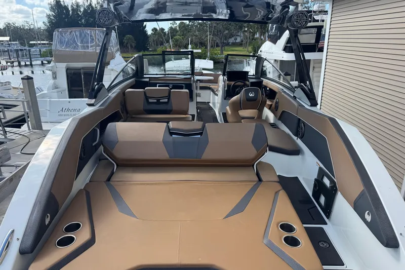 Slide: The Image of 2022 Scarab 285 ID boat interior with brown seating and modern design. - 23