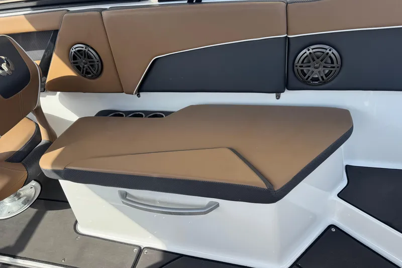Slide: The Image of 2022 Scarab 285 ID boat interior with brown seating and built-in speakers. - 24
