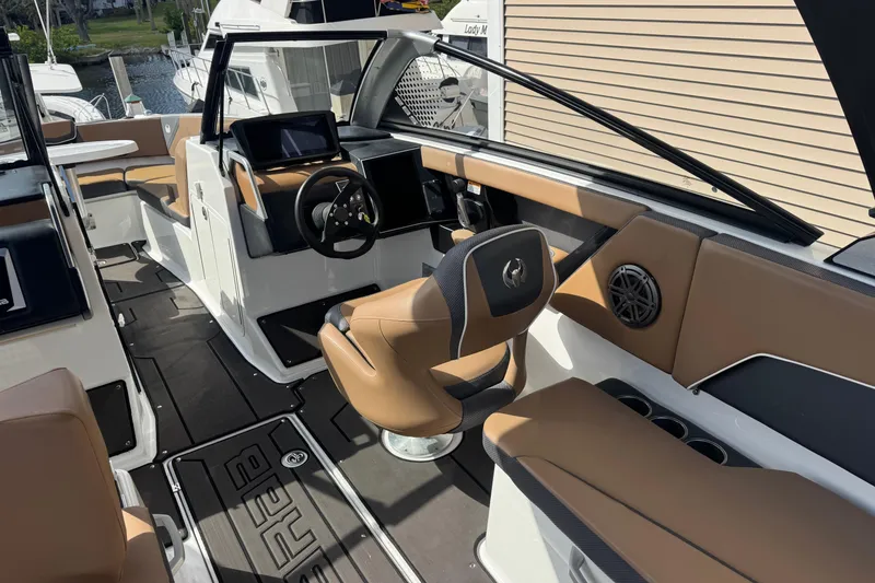 Slide: The Image of 2022 Scarab 285 ID boat interior with modern dashboard and tan seating. - 25