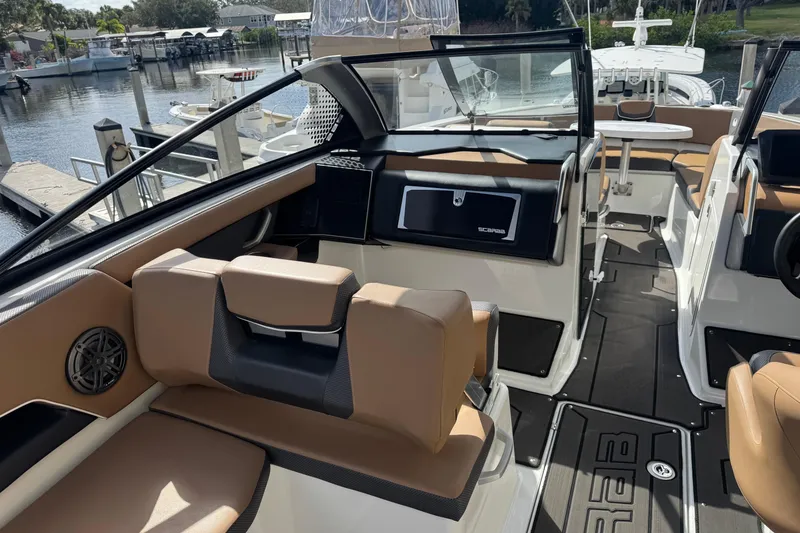 Slide: The Image of Interior of 2022 Scarab 285 ID boat with tan seating and modern dashboard. - 26