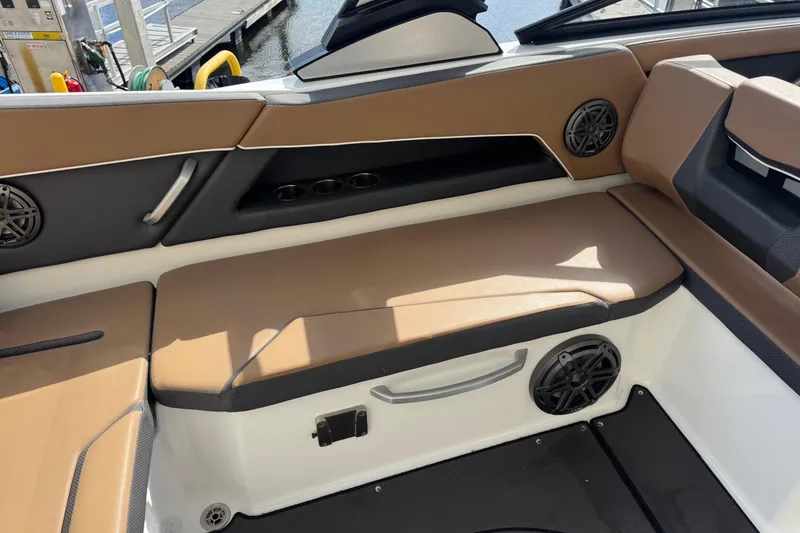 Slide: The Image of 2022 Scarab 285 ID boat interior with tan seating and speaker system. - 27