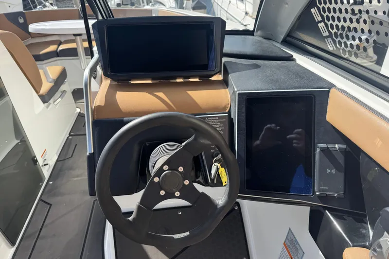 Slide: The Image of 2022 Scarab 285 ID boat dashboard with steering wheel and digital displays. - 32