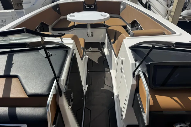 Slide: The Image of 2022 Scarab 285 ID boat interior with tan seating and a round table. - 36