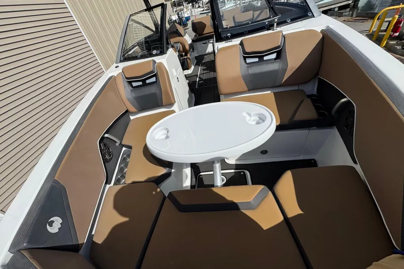 Slide: The Image of 2022 Scarab 285 ID boat interior with brown seating and a white table. - 39