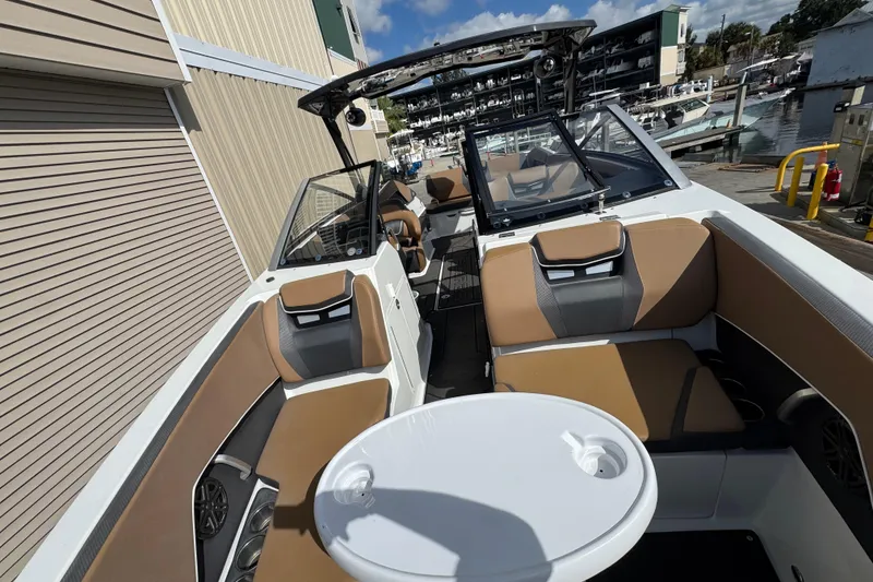 Slide: The Image of 2022 Scarab 285 ID boat interior with tan seating and a round table. - 40