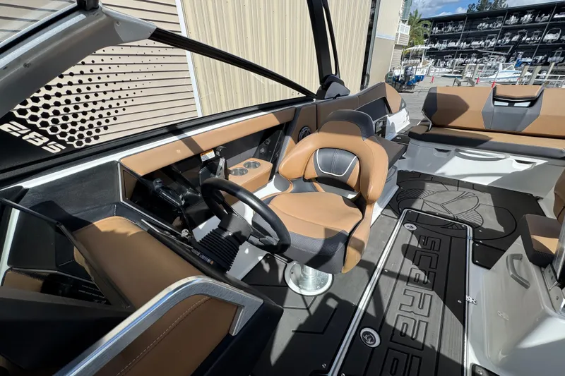 Slide: The Image of 2022 Scarab 285 ID boat interior with modern helm, tan seating, and sleek design. - 43
