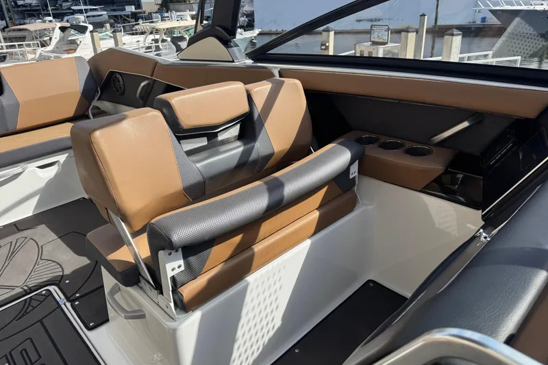 Slide: The Image of 2022 Scarab 285 ID boat interior with tan and black seating, cup holders, and modern design. - 45