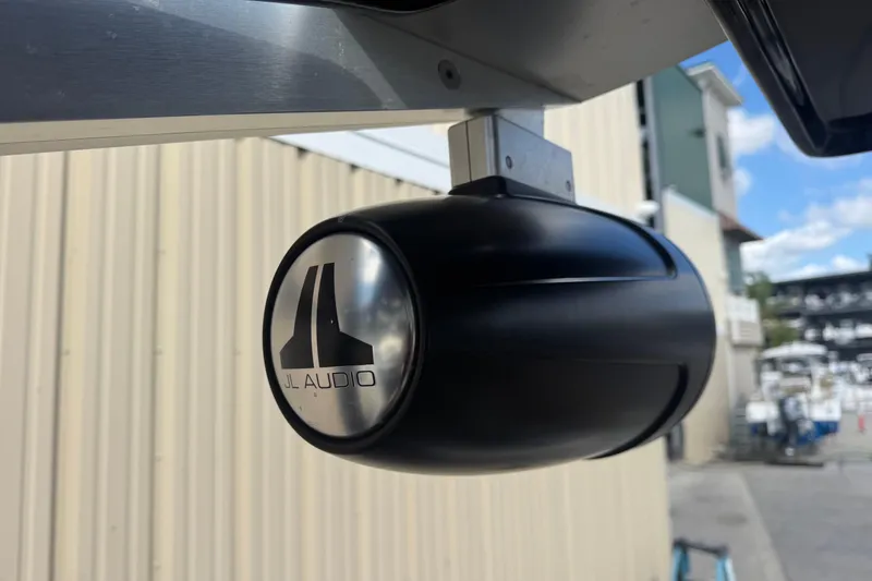 Slide: The Image of JL Audio speaker mounted on a 2022 Scarab 285 ID boat, outdoor setting. - 48