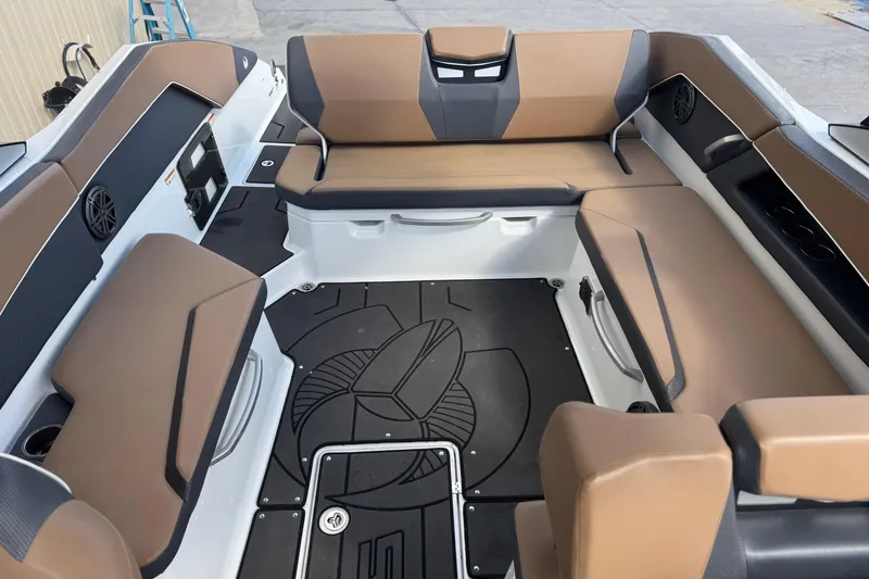 Slide: The Image of 2022 Scarab 285 ID boat interior with brown seating and black flooring. - 49