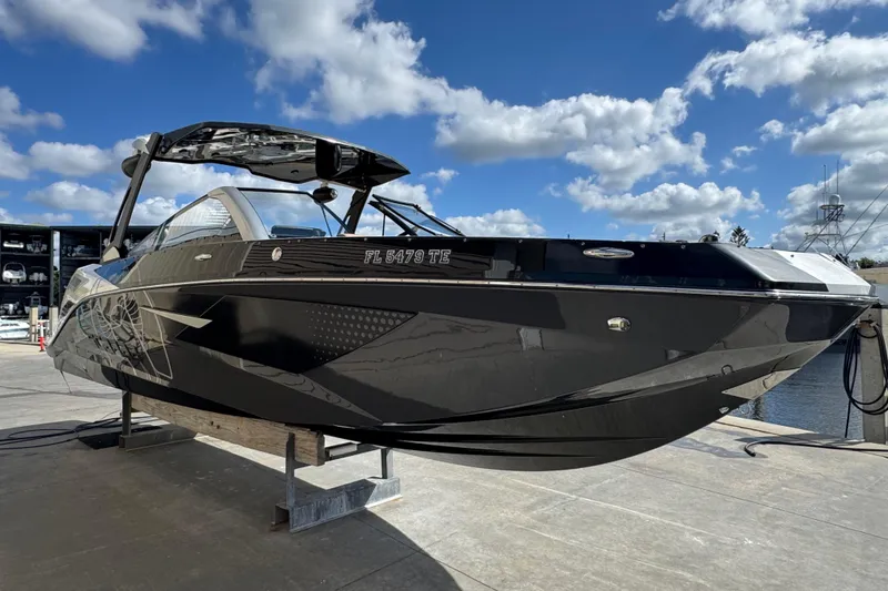 Slide: The Image of 2022 Scarab 285 ID boat on dock under blue sky with clouds. - 5