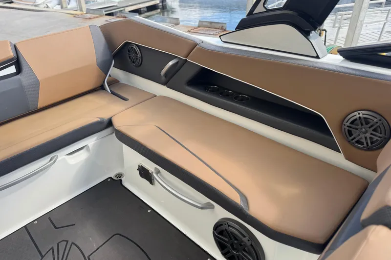Slide: The Image of Interior of 2022 Scarab 285 ID boat with tan seating and speaker system. - 52