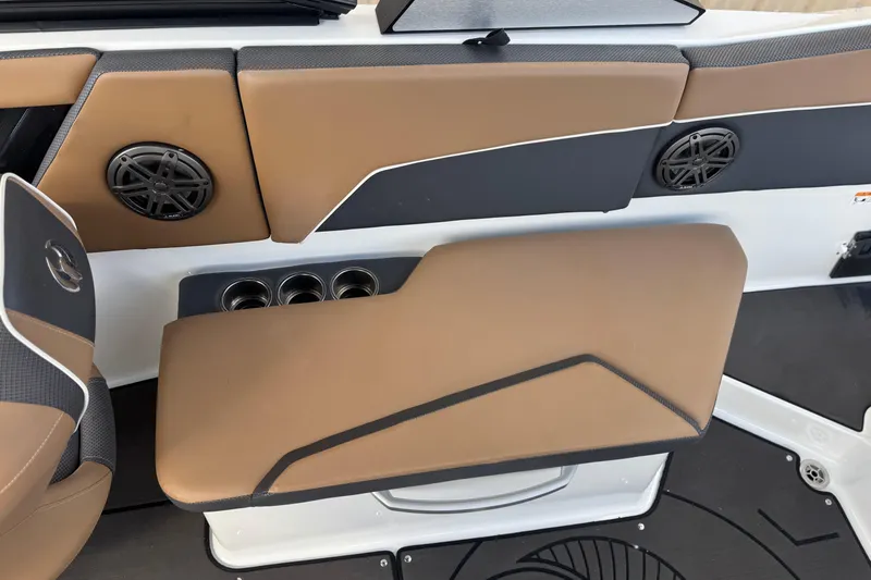 Slide: The Image of 2022 Scarab 285 ID boat interior with brown seating, cup holders, and speakers. - 54
