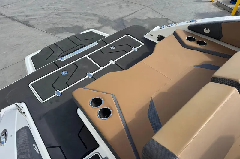 Slide: The Image of 2022 Scarab 285 ID boat interior with tan seating and cup holders. - 56