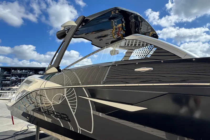 Slide: The Image of 2022 Scarab 285 ID boat with sleek black design under a blue sky. - 6