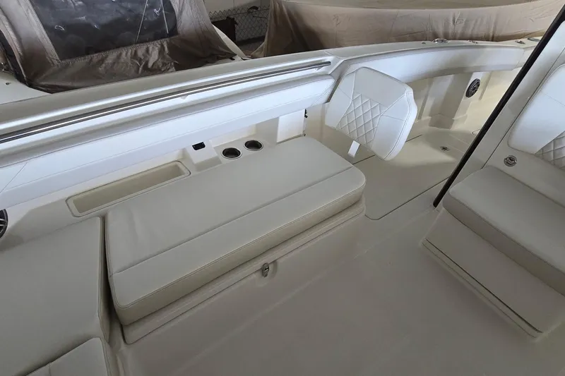 Slide: The Image of 2024 WorldCat 280 CC-X boat interior with white cushioned seating and cup holders. - 10