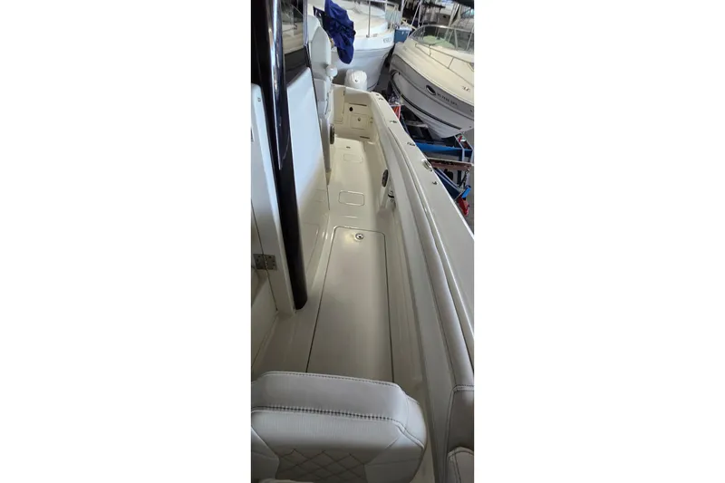 Slide: The Image of 2024 WorldCat 280 CC-X boat interior with white seating and sleek design. - 16