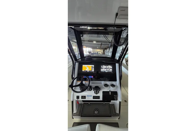 Slide: The Image of 2024 WorldCat 280 CC-X boat dashboard with navigation screens and steering wheel. - 19