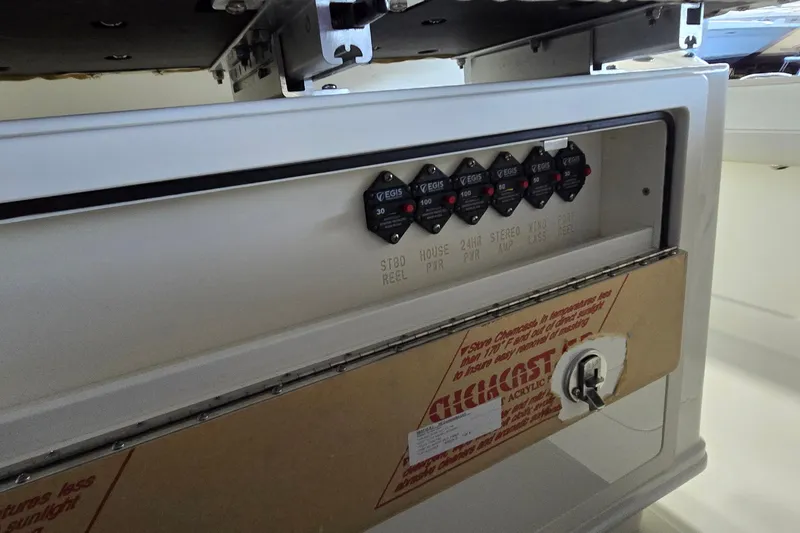 Slide: The Image of Control panel of 2024 WorldCat 280 CC-X boat with labeled switches and protective cover. - 23