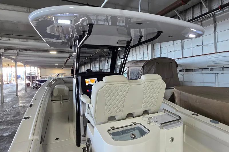 Slide: The Image of 2024 WorldCat 280 CC-X boat interior with dual seats and modern dashboard in a warehouse. - 26