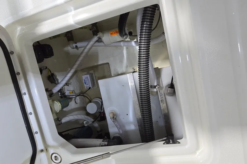 Slide: The Image of 2024 WorldCat 280 CC-X boat interior compartment with wiring and plumbing details. - 32