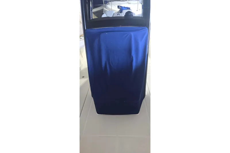 Slide: The Image of 2024 WorldCat 280 CC-X boat interior with blue cover and window reflection. - 35