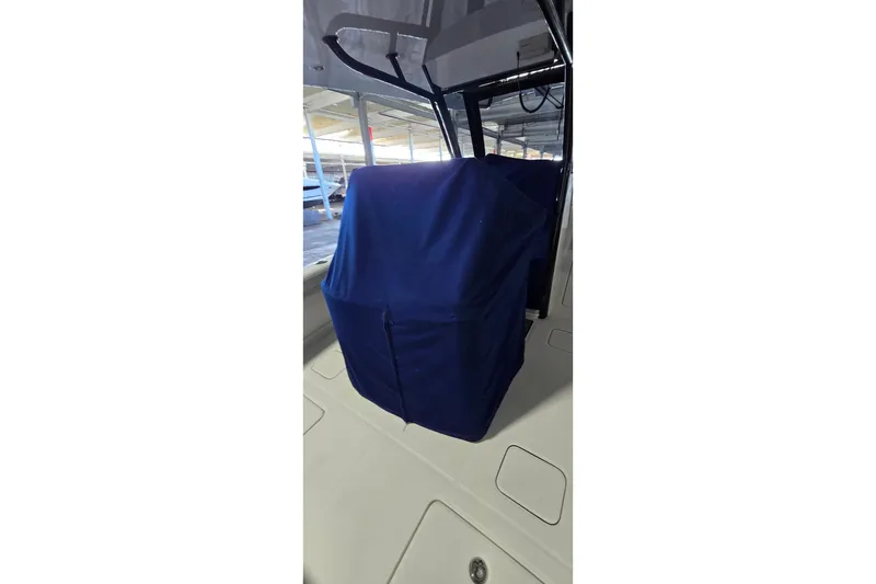 Slide: The Image of 2024 WorldCat 280 CC-X boat interior with blue cover, showcasing console area. - 37